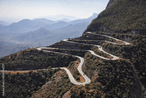 Sunset view of the winding Leba Pass road with mountain silhouettes in the background – iconic serpentine landscape in Angola