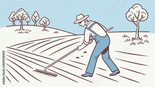 A farmer in overalls and hat raking a field with trees in the background on a sunny day outdoors