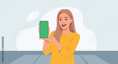A cheerful young woman presents a modern smartphone with a vibrant green screen, perfect for showcasing digital content and app interfaces.