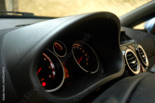 A detailed macro shot of a car's instrument panel. The speedometer, rev counter, and other indicators on the Opel Corsa dashboard are visible, symbolizing the essence of driving and vehicle control.
