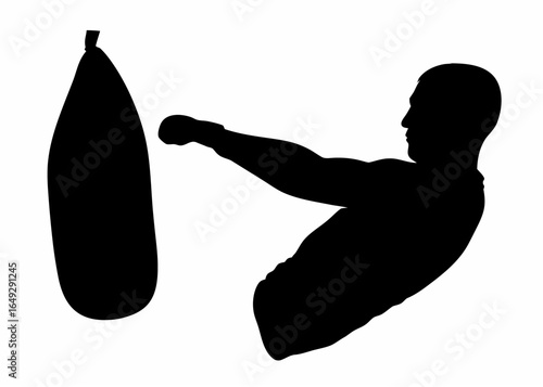 Silhouette of a man punching a punching bag with his right hand during a training session in a gym