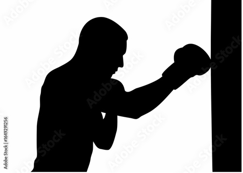 Silhouette of a boxer punching a heavy bag with a boxing glove in a training or workout session