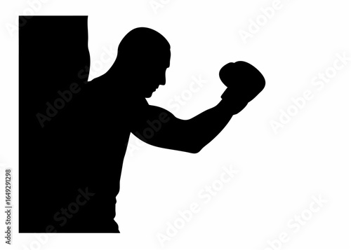 Silhouette of a boxer with gloves in a fighting stance against a wall with arm raised ready to punch