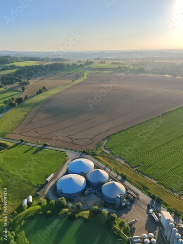 Aerial view large biogas power plant with silos and tanks for renewable energy production.