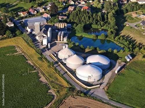 Aerial view large biogas power plant with silos and tanks for renewable energy production.	
