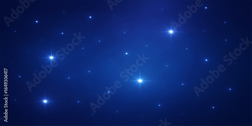 Abstract dark blue starry sky with glowing particles and bright cosmic light