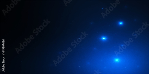 Abstract starry night sky with glowing blue particles and a cosmic dust nebula