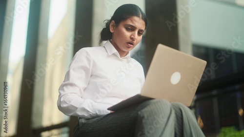 Worried young indian woman with crossed fingers while get notification email and feeling upset reading bad negative news message outdoors Disappointment concept