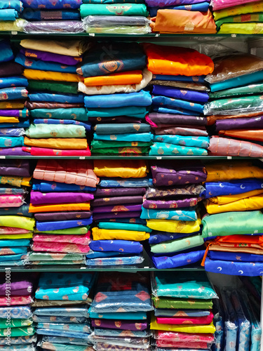 Wallpaper Mural Neatly stacked colorful silk saris in racks in a textile shop, These exquisite, expensive sarees are famous for their gold and silver zari, brocade. Incredible India. Torontodigital.ca