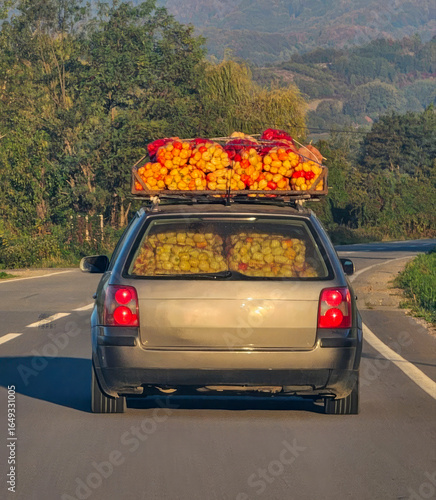 Fotografie Car laden with vibrant pumpkins and apples, heralding Samhain and Oktoberfest, r