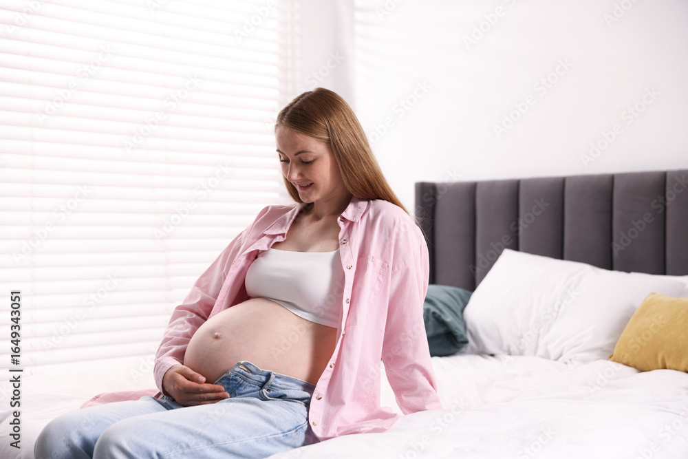 Beautiful pregnant woman on bed at home Beautiful pregnant woman on bed at home