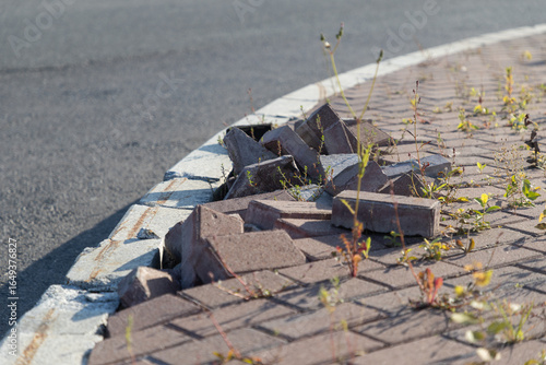 Poorly laid, buckled paving tiles on the city sidewalk