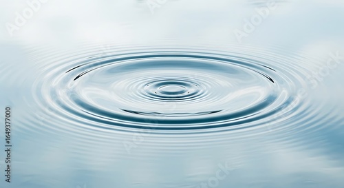 A gentle ripple effect spreading across the surface of a calm body of water in a light blue hue