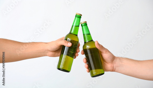 Hand clinking their bottles of beer together on white background