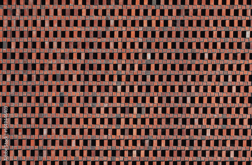 Red brick wall with geometric ventilation pattern