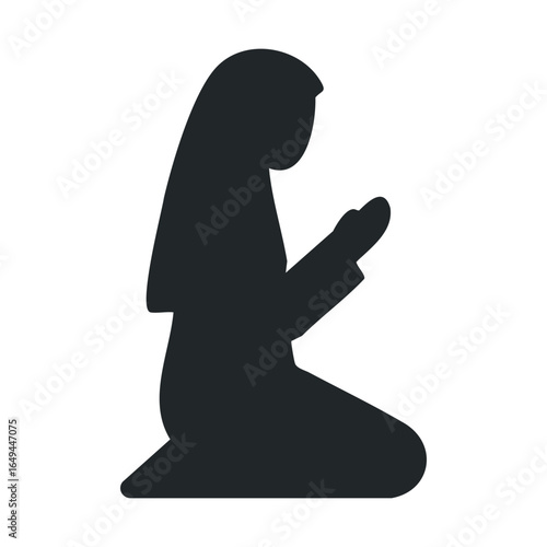 Silhouette of a praying woman in kneeling position