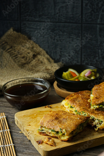 Martabak telur. Egg martabak or thick folded crepe made from egg, meat, and vegetables.