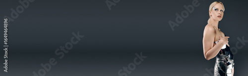 Bild auf Leinwand Futuristic blonde woman showcasing creative fashion in a contemporary studio set
