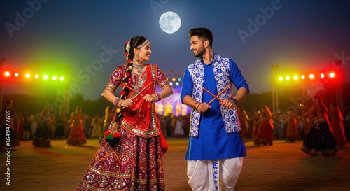 Young couple playing Garba under a moonlit Navratri sky