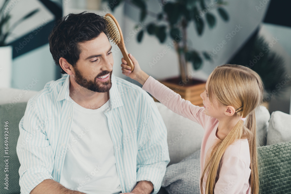 Fototapeta premium Cheerful Father and young daughter share a joyful bonding moment during a relaxed weekend at home