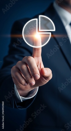 Professional businessman pointing to glowing pie chart showing business growth with a modern feel and dark background