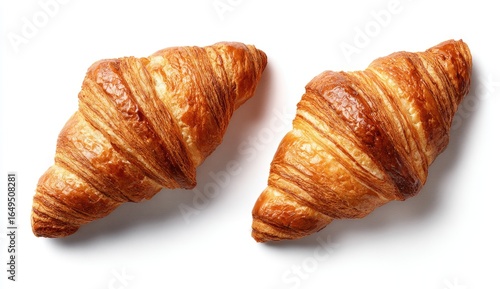 Two golden croissants, top view, on a white background