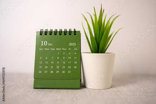 The desktop calendar for October 2025 is on the desk, where there is a place to copy.
