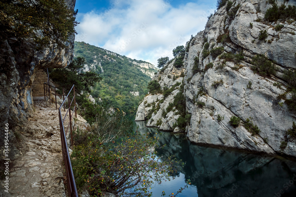 Fototapeta premium Walking trail along Verdon Gorge with cliff and river, Quinson, Provence; France