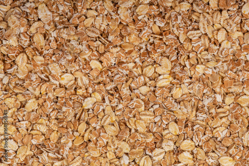 Macro shot of oat flakes showing their natural texture and color, great for backgrounds or nutrition-related concepts.