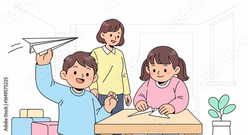 A mother watches her son launch a paper airplane while her daughter folds another at a table in a bright room.