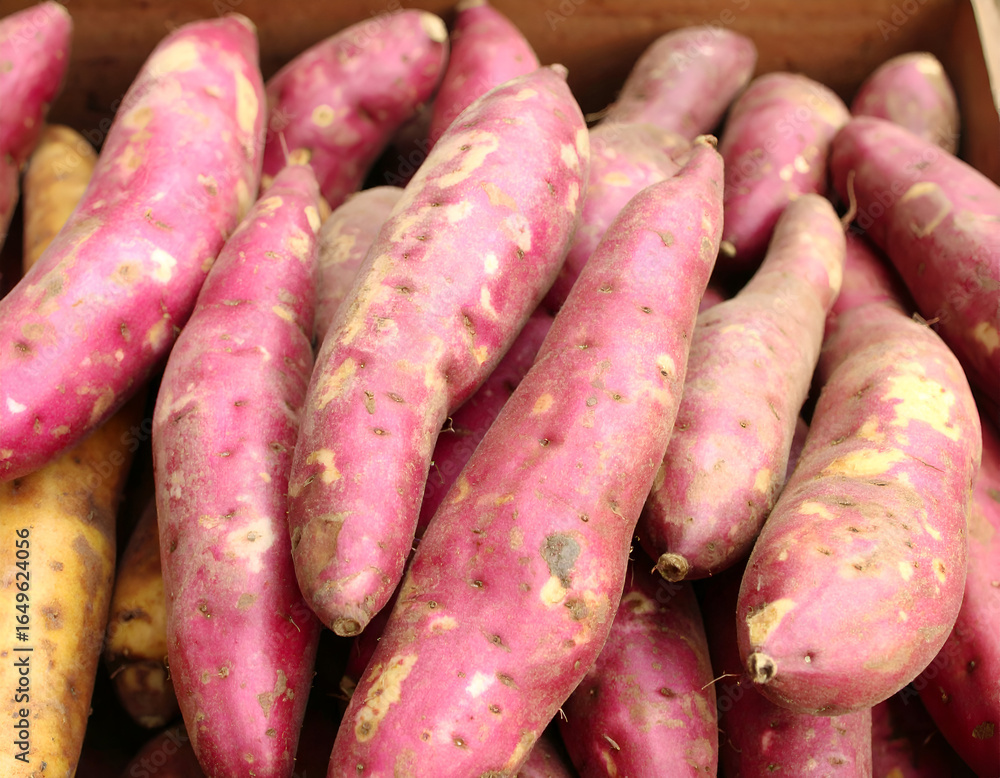 Closeup of Pink and Brown Sweet Potatoes in a Wooden Crate Closeup of Pink and Brown Sweet Potatoes in a Wooden Crate