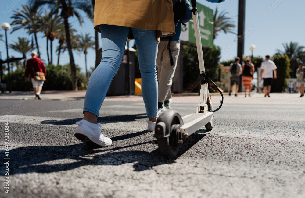 Obraz premium Woman with e scooter in town, transportation concept