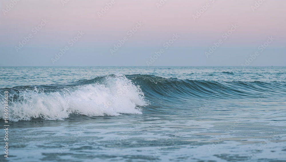 A small wave crashing in the ocean at sunset time A small wave crashing in the ocean at sunset time