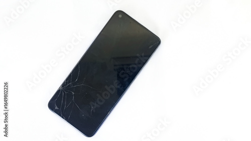 Smartphone with cracked screen on white background.