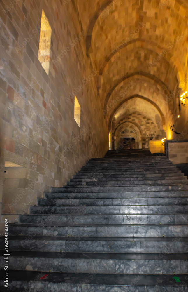 Obraz premium The interior grand staircase of the Palace of the Grand Master of the Knights of Rhodes with huge vaulted ceilings, Greece