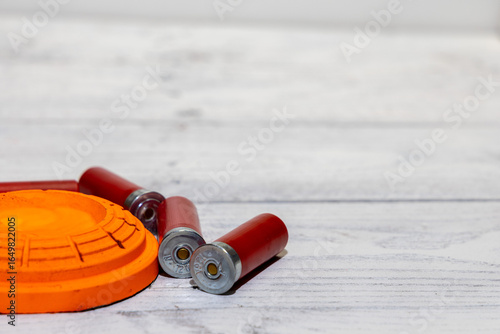 pigeon sporting clays target and shotgun shells  with copy space  