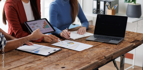 Fototapeta Business team have a discussion on financial report, business analyzing marketing data at office