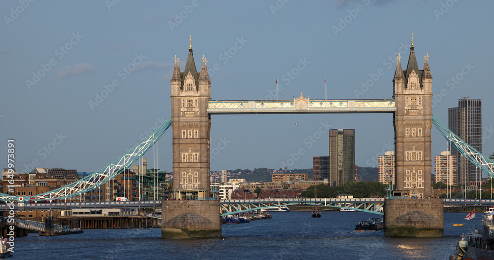 Fototapeta premium Tower Bridge, an iconic symbol of London, basking in the afternoon sunlight with the cityscape in the background