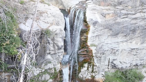 Upper section of Mill Creek Falls cascading through a rocky canyon in Lassen Volcanic National Park, California, surrounded by forested mountain scenery.