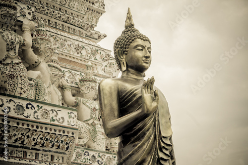 Gold statue at Wat Arun is one of a famous Buddhist temple in the Bangkok, Thailand