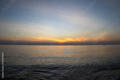 Beautiful sunset on the sea beach with coconut tree for travel in holiday