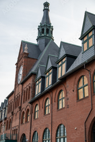 Wallpaper Mural Historic Red Brick Building with Clock Tower and Illuminated Windows Torontodigital.ca