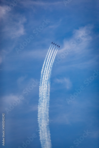 Aerospace Extravaganza: Blue Jet Contrails against Azure Sky