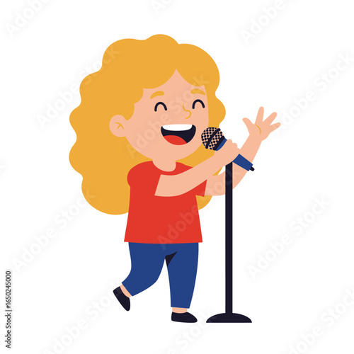 Cheerful young girl with wavy blonde hair singing into a microphone wearing a red shirt and blue pants.