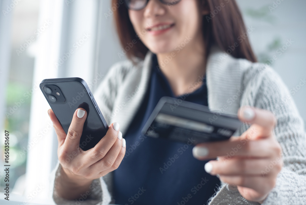 Young asian woman using mobile phone and credit card for mobile banking, digital payment via mobile app. Happy user using smartphone for online shopping and internet payment, financial technology Young asian woman using mobile phone and credit card for mobile banking, digital payment via mobile app. Happy user using smartphone for online shopping and internet payment, financial technology
