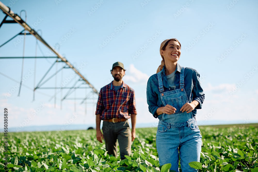 Fototapeta premium Happy farmer and her husband working in the field.