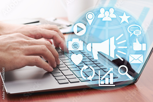 Man hand using laptop with social media business icons for tech connection concept