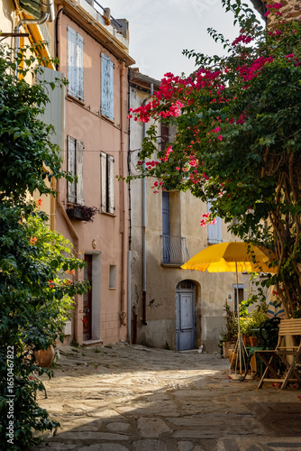 Fototapeta Naklejka Na Ścianę i Meble -  View of colourful Collioure, narrow streets and yellow, pink, orange houses, summer vacation destination town with historical buidings and beaches, Pyrenees-Orientales, France
