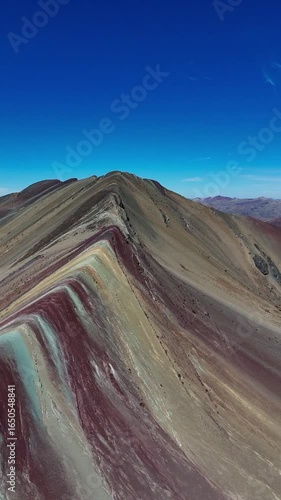 Vertical aerial footage of Rainbow Mountain, in the Peruvian Andes, located in the Cusco region
