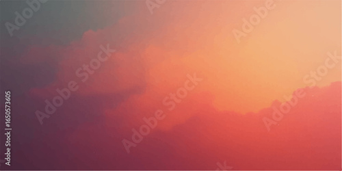 Yellow and red clouds at sunrise casting a beautiful light over the foggy mountains
